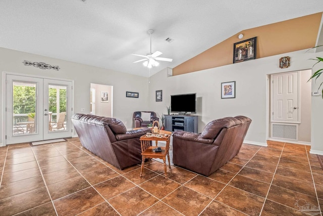 living room with high vaulted ceiling, french doors, ceiling fan, dark tile patterned floors, and a textured ceiling