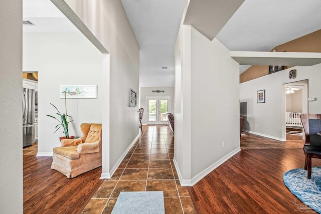 corridor with dark hardwood / wood-style floors and french doors