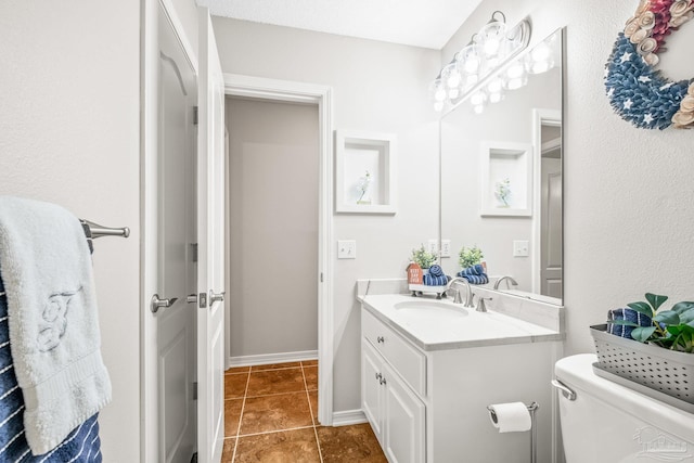 bathroom featuring tile patterned flooring, vanity, and toilet