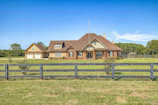 view of front of house with a garage and a front lawn