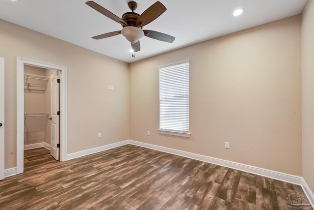 empty room with dark hardwood / wood-style floors and ceiling fan