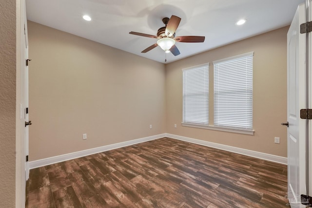 spare room with dark hardwood / wood-style floors and ceiling fan