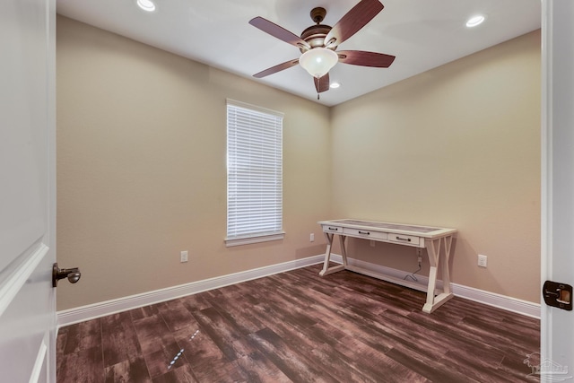 spare room with dark hardwood / wood-style floors and ceiling fan