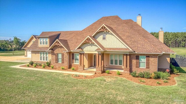 craftsman inspired home with a front lawn