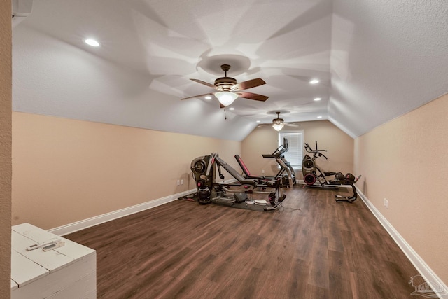 exercise area with dark wood-type flooring and vaulted ceiling