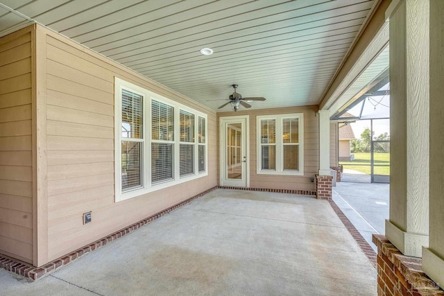 exterior space with ceiling fan and glass enclosure