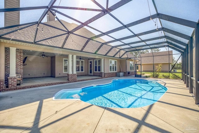 view of swimming pool featuring a lanai, a patio, and ceiling fan