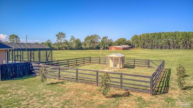 view of yard with an outbuilding and a rural view