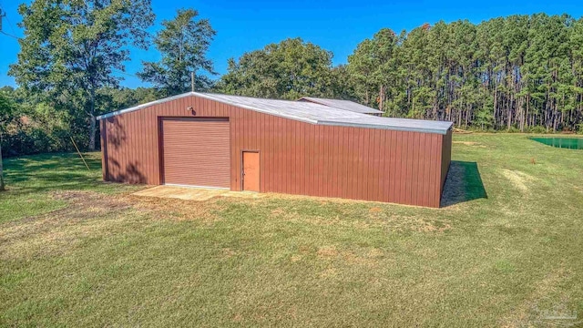 view of outbuilding with a garage and a yard