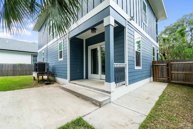 277 Seamarge Ln, Pensacola, FL 32507 - entrance to property featuring board and batten siding, central air condition unit, and a patio area