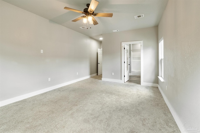 277 Seamarge Ln, Pensacola, FL 32507 - unfurnished bedroom with light colored carpet, baseboards, a walk in closet, and a ceiling fan