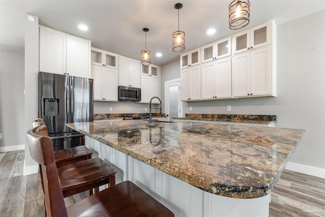 277 Seamarge Ln, Pensacola, FL 32507 - kitchen featuring appliances with stainless steel finishes, baseboards, a sink, a large island, and white cabinets