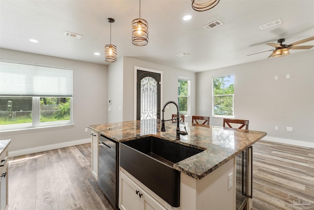 277 Seamarge Ln, Pensacola, FL 32507 - kitchen with stainless steel dishwasher, a sink, light wood finished floors, baseboards, and recessed lighting