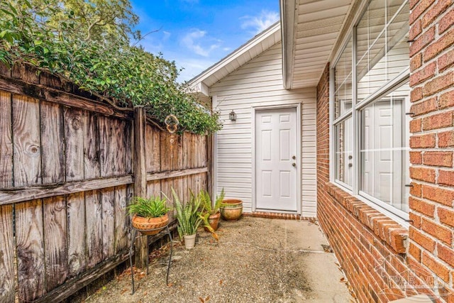 entrance to property featuring a patio