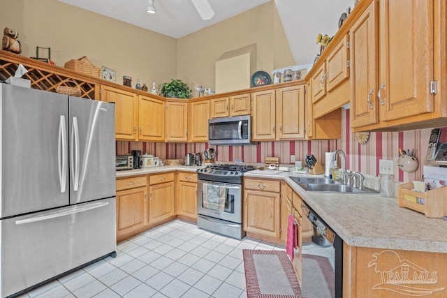 kitchen with sink, stainless steel appliances, ceiling fan, and light tile patterned flooring