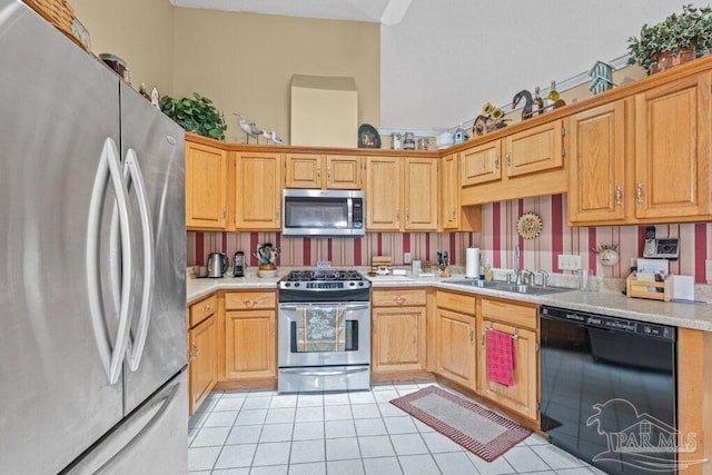 kitchen featuring light tile patterned flooring, stainless steel appliances, and sink