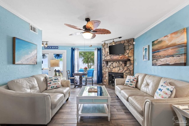 living area featuring crown molding, visible vents, wood finished floors, and a ceiling fan