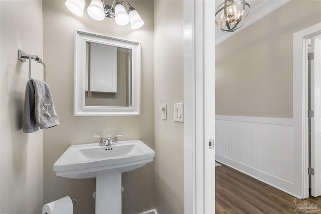 1904 Lodgepole Dr, Milton, FL 32583 - bathroom featuring a chandelier, a wainscoted wall, and wood finished floors