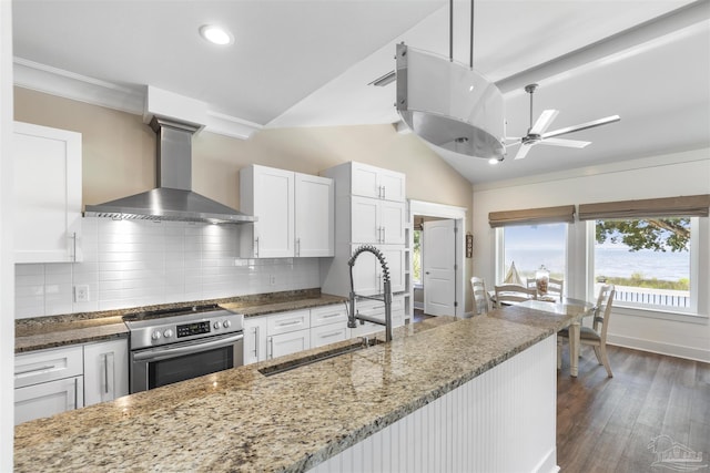 1904 Lodgepole Dr, Milton, FL 32583 - kitchen with wall chimney range hood, stainless steel range with electric stovetop, a sink, tasteful backsplash, and white cabinetry