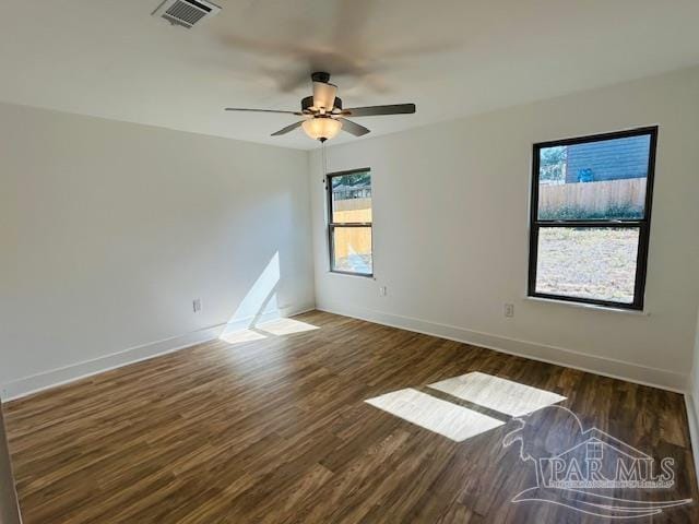 spare room featuring ceiling fan and dark hardwood / wood-style floors