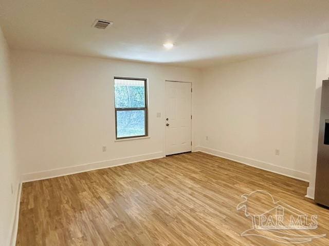 empty room with hardwood / wood-style flooring