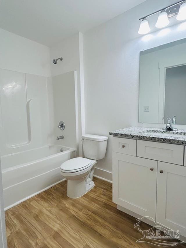 full bathroom featuring vanity, toilet, hardwood / wood-style flooring, and tub / shower combination