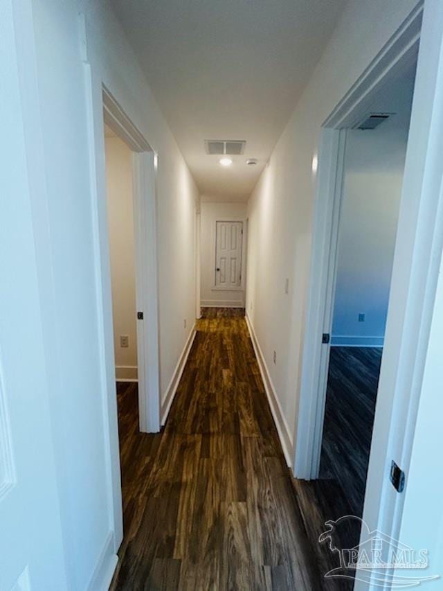 hallway with dark hardwood / wood-style floors