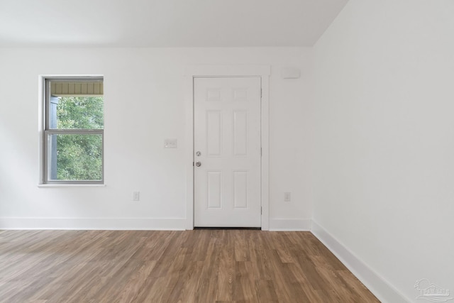 unfurnished room with wood-type flooring