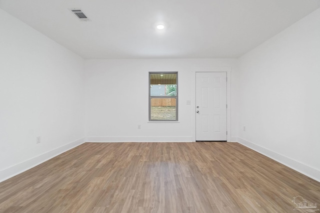 empty room with hardwood / wood-style floors