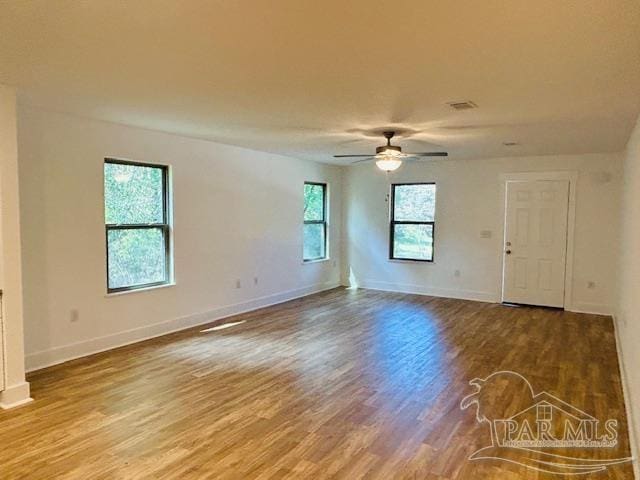 unfurnished room with a wealth of natural light, ceiling fan, and hardwood / wood-style flooring