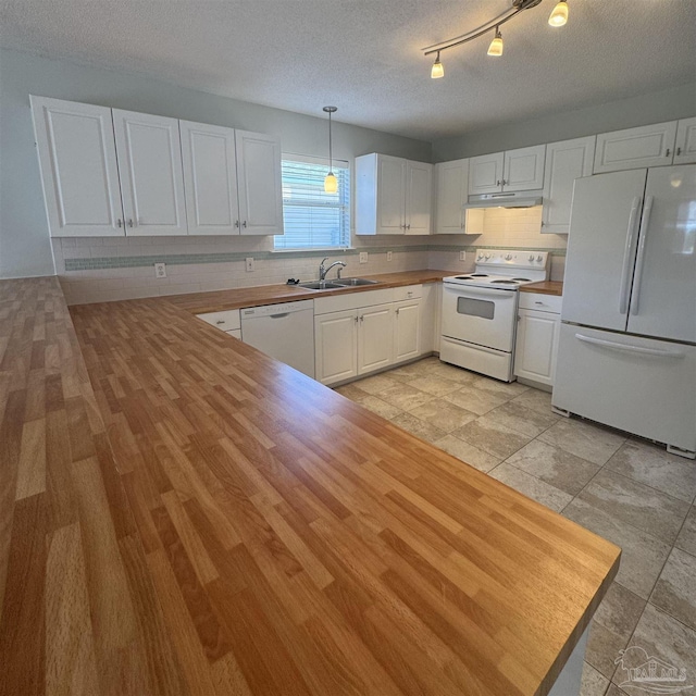 kitchen with a sink, white appliances, white cabinetry, decorative backsplash, and under cabinet range hood