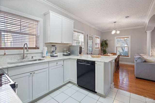 kitchen featuring pendant lighting, a wealth of natural light, dishwasher, sink, and white cabinets