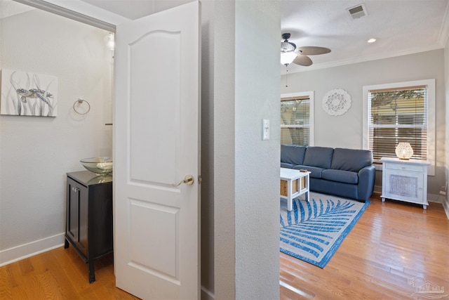 interior space featuring hardwood / wood-style flooring, ceiling fan, and ornamental molding