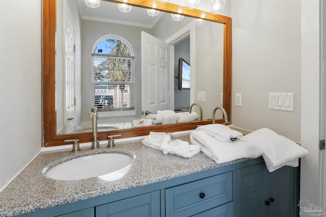 bathroom with vanity and ornamental molding