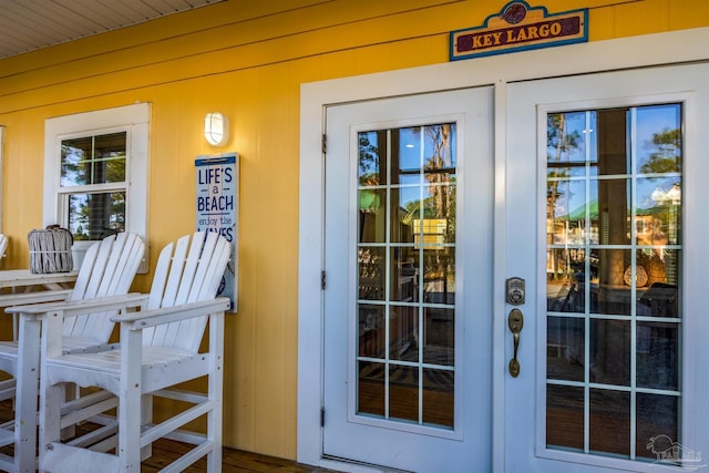 doorway to property featuring covered porch and french doors