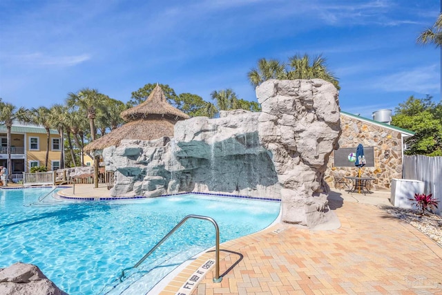 view of swimming pool featuring pool water feature