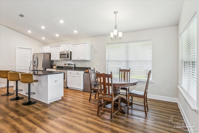 5018 Quarter Deck St, Pensacola, FL 32526 - dining room featuring dark wood-style floors, baseboards, a chandelier, recessed lighting, and lofted ceiling