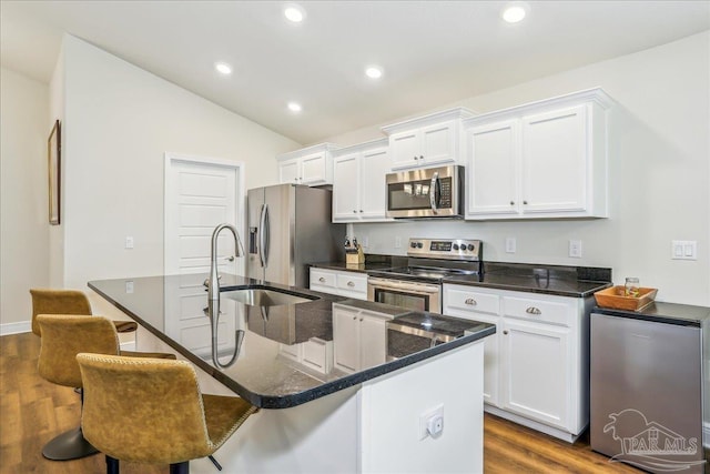 5018 Quarter Deck St, Pensacola, FL 32526 - kitchen with stainless steel appliances, dark wood-style floors, a sink, white cabinets, and vaulted ceiling