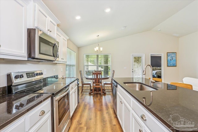 5018 Quarter Deck St, Pensacola, FL 32526 - kitchen with stainless steel appliances, a sink, vaulted ceiling, light wood-style flooring, and white cabinets