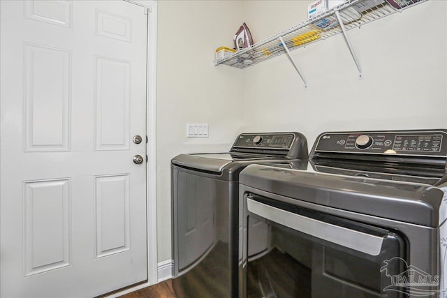 5018 Quarter Deck St, Pensacola, FL 32526 - washroom featuring separate washer and dryer and dark wood-style flooring