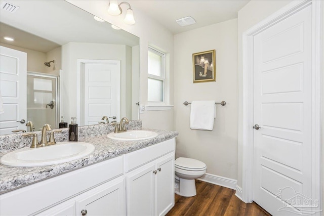 5018 Quarter Deck St, Pensacola, FL 32526 - full bathroom with a stall shower, toilet, wood finished floors, double vanity, and baseboards