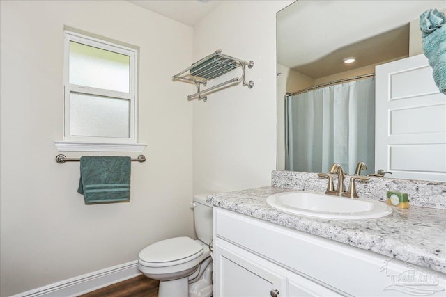 5018 Quarter Deck St, Pensacola, FL 32526 - full bathroom with vanity, toilet, baseboards, and wood finished floors