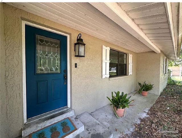 12508 Palomino Ct, Tampa, FL 33626 - view of exterior entry featuring stucco siding