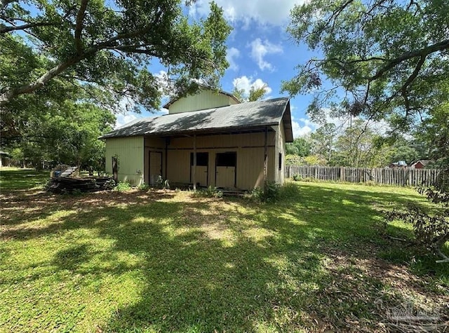 12508 Palomino Ct, Tampa, FL 33626 - view of pole building featuring a lawn and fence