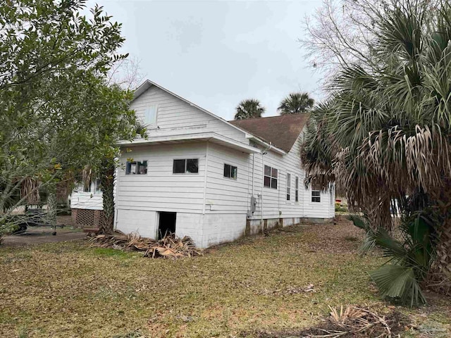 view of property exterior featuring a lawn