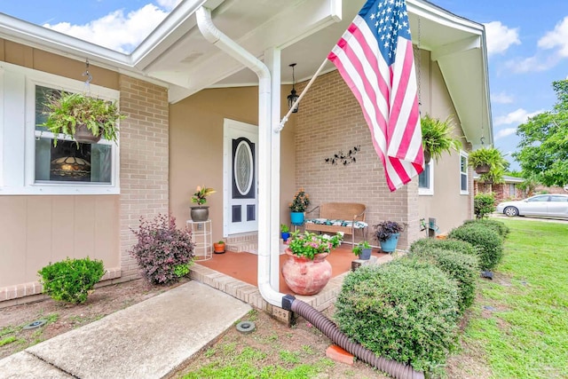 entrance to property featuring a yard