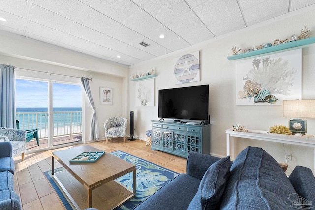 tiled living room featuring visible vents, a drop ceiling, and recessed lighting