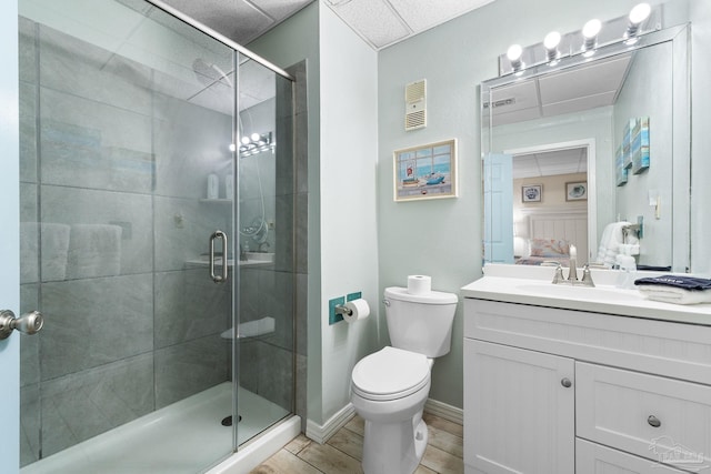 full bathroom featuring connected bathroom, toilet, visible vents, a shower stall, and wood tiled floor