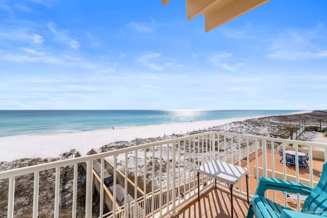 balcony featuring a water view and a view of the beach