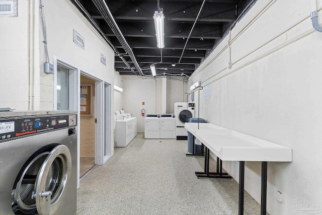 common laundry area featuring washing machine and dryer